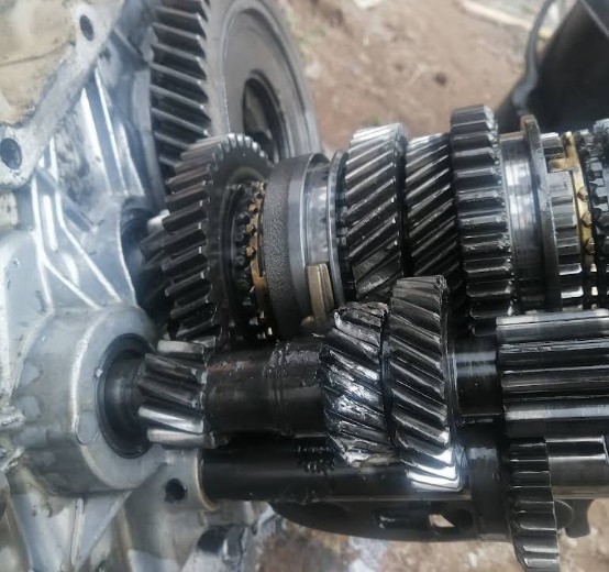 Disassembled gearbox showing gear clusters and shafts